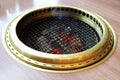 Grille on stove with the charcoal on fire below