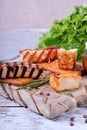 Grilled adyghe cheese, crackers, red jam, spices and cress salad on the wooden board Royalty Free Stock Photo