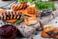 Grilled adyghe cheese, crackers, red jam, spices and cress salad on the wooden board Royalty Free Stock Photo