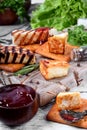 Grilled adyghe cheese, crackers, red jam, spices and cress salad on the wooden board Royalty Free Stock Photo