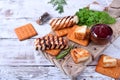 Grilled adyghe cheese, crackers, red jam, spices and cress salad on the wooden board Royalty Free Stock Photo