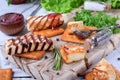 Grilled adyghe cheese, crackers, red jam, spices and cress salad on the wooden board Royalty Free Stock Photo