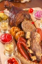 Grilled appetizing sausages on platter. Octoberfest traditional food. Tasty grilled sausages, german food. Delicious