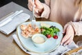 Grilled Argentine shrimp with mango-jalapeno sauce. Lunch in a restaurant, a woman eats delicious and healthy food