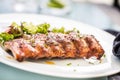 Grilled barbecue pork ribs in a white plate as menu in pub. Royalty Free Stock Photo