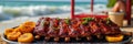 Grilled barbecue ribs with citrus on beachside table by the ocean Royalty Free Stock Photo