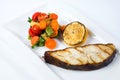 Grilled barramundi steak with lemon and vegetables Royalty Free Stock Photo