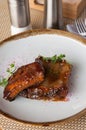 Grilled pork ribs in spicy chili sauce on a plate Royalty Free Stock Photo