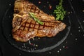 Grilled BBQ T-Bone Steak or porterhouse steak with Fresh Rosemary. American cuisine. Restaurant menu, dieting, cookbook recipe. Royalty Free Stock Photo