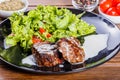 Grilled beaf steak meat with fresh vegetable salad and tomatoes Royalty Free Stock Photo