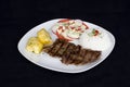 Grilled beef fillet assorted peruvian dish chili sauce, rice, potatoes, tomatoes