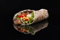 Grilled beef Kebab Doner Wrap with onion, parsley and tomato on reflective blÃÂack backgrund Royalty Free Stock Photo