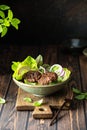 Grilled beef patties served with fresh crusty green salad Royalty Free Stock Photo