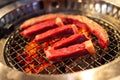 Grilled beef or pork meat grilled on charcoal grill. Cooking yakiniku Japanese style Royalty Free Stock Photo