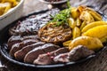 Grilled beef Rib Eye steak with garlic american potatoes rosemary salt and spices Royalty Free Stock Photo