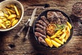 Grilled beef Rib Eye steak with garlic american potatoes rosemary salt and spices Royalty Free Stock Photo