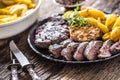 Grilled beef Rib Eye steak with garlic american potatoes rosemary salt and spices Royalty Free Stock Photo
