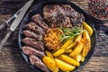 Grilled beef Rib Eye steak with garlic american potatoes rosemary salt and spices Royalty Free Stock Photo