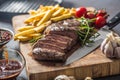 Beef Rib Eye steak with roasted potatoes bbq sauce garlic mushrooms and spices. Royalty Free Stock Photo