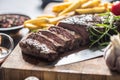 Beef Rib Eye steak with roasted potatoes bbq sauce garlic mushrooms and spices. Royalty Free Stock Photo