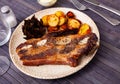 Grilled beef ribs with fried potatoes and artichokes Royalty Free Stock Photo