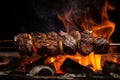 grilled beef shishkabob over open flame, with flames and smoke visible