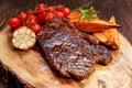 Grilled Beef Sirloin Steak on wooden board with vegetables. Royalty Free Stock Photo