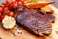 Grilled Beef Sirloin Steak on wooden board with vegetables. Royalty Free Stock Photo