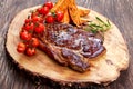 Grilled Beef Sirloin Steak on wooden board with vegetables. Royalty Free Stock Photo