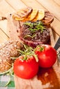 Grilled beef steak, baked potatoes and vegetable on wooden bread