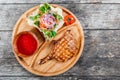 Grilled beef steak on bone, fresh salad, grilled vegetables and tomato sauce on cutting board on wooden background Royalty Free Stock Photo