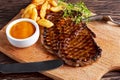 Grilled Beef Steak with Chips and Mango souce on wooden board. Royalty Free Stock Photo