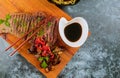 Grilled beef steak with chopstick on cutting board