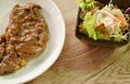 Grilled beef steak dressing gravy sauce with French fries dressing ketchup on plate and salad Royalty Free Stock Photo