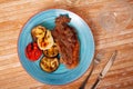 Grilled beef steak with grilled eggplant, onion and tomatoes Royalty Free Stock Photo