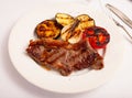 Grilled beef steak with grilled eggplant, onion and tomatoes Royalty Free Stock Photo