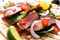 Grilled beef steak. Fajitos, tortillas with salsa, chili and beef on a dark background Royalty Free Stock Photo