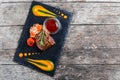 Grilled beef steak with fresh salad and bbq sauce on stone slate background on wooden background Royalty Free Stock Photo