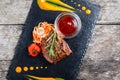 Grilled beef steak with fresh salad and bbq sauce on stone slate background on wooden background close up. Royalty Free Stock Photo