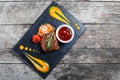 Grilled beef steak with fresh salad and bbq sauce on stone slate background on wooden background close up. Hot Meat Dishes. Royalty Free Stock Photo