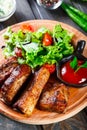 Grilled Beef steak with fresh vegetable salad, tomatoes and sauce on wooden Royalty Free Stock Photo