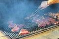 Juicy raw steaks grilling beef steak on the grill Royalty Free Stock Photo