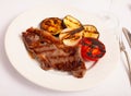 Grilled beef steak with grilled eggplant, onion and tomatoes Royalty Free Stock Photo