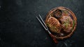 Grilled beef steak medium rare on a black stone table. Top view. Royalty Free Stock Photo