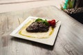 Grilled beef steak and mushrooms with tomatoes on white plate Royalty Free Stock Photo