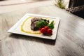 Grilled beef steak and mushrooms with tomatoes on wood table Royalty Free Stock Photo