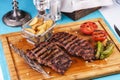 grilled beef steak with grilled pepper, onion rings and tomatoes. Royalty Free Stock Photo