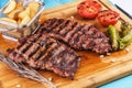 Grilled beef steak with grilled pepper, onion rings and tomatoes. Royalty Free Stock Photo