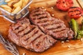 Grilled beef steak with grilled pepper, onion rings and tomatoes. Royalty Free Stock Photo