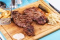 Grilled beef steak with grilled pepper, onion rings and tomatoes. Royalty Free Stock Photo